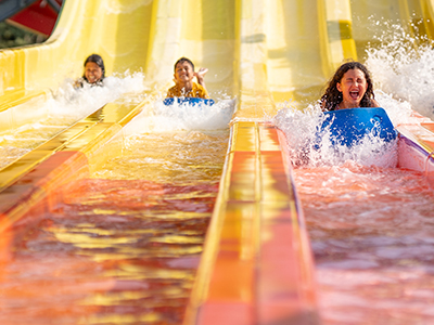 Kids having fun on water race slide
