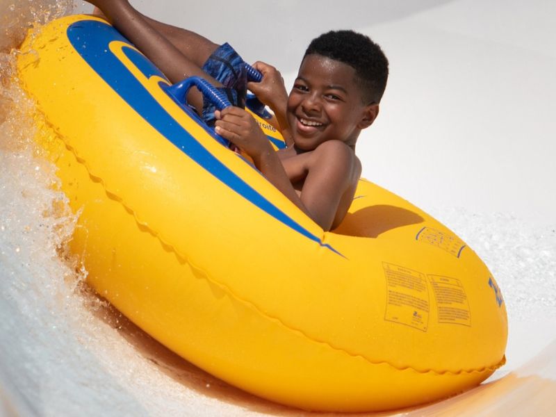 Boy riding tube on water slide Wet n Wild 